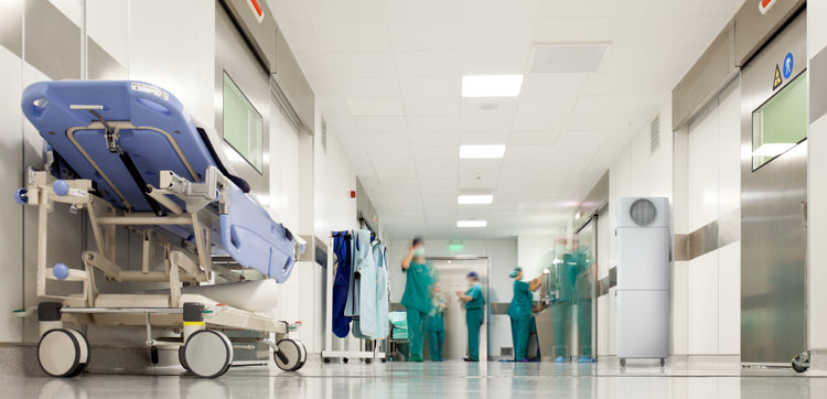 hospital hallway showing stretcher and INOVA commercial air purifier